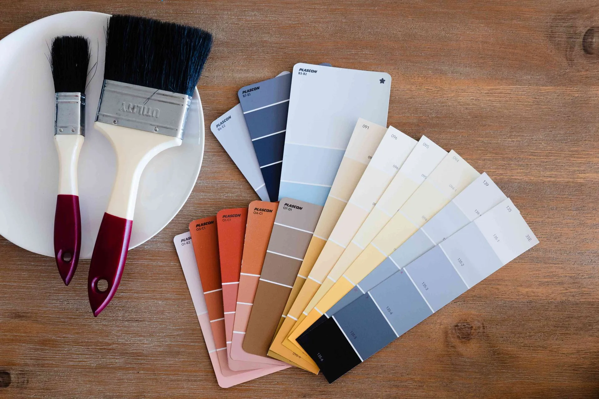 Vibrant paint swatches with brushes, offered by Paint Masters Painting Contractors in Venice, FL